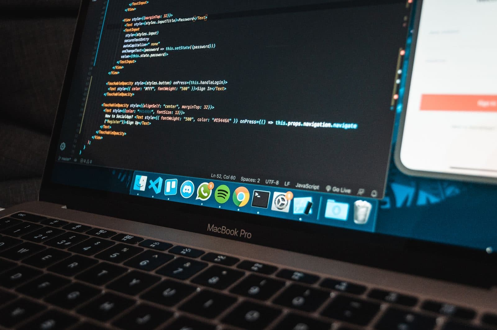 Laptop on a desk displaying program code